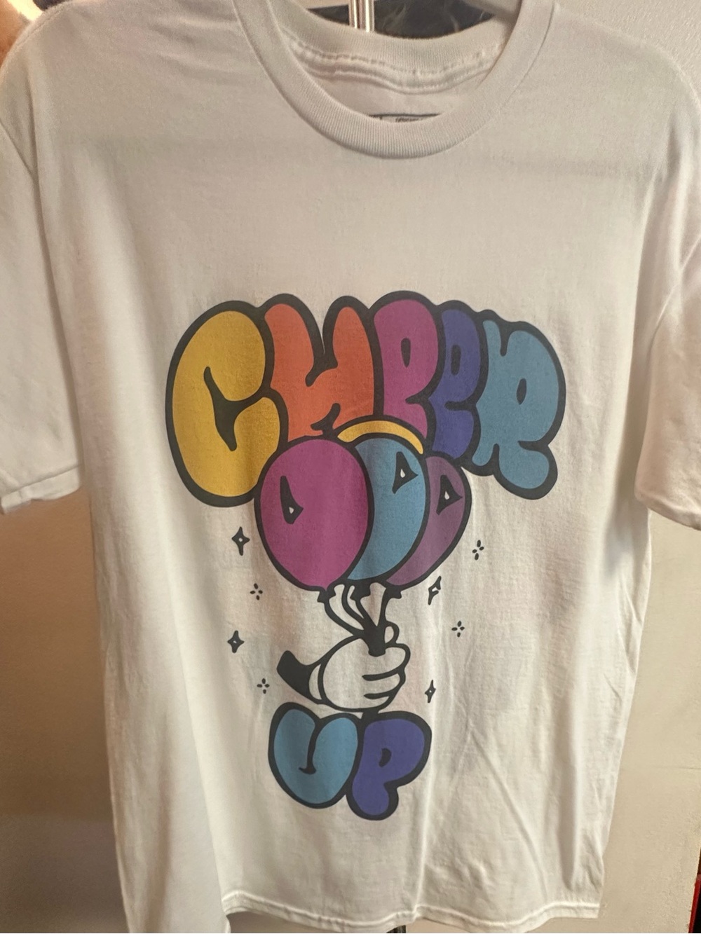 White Graphic Tee "Cheer Up" with Colorful Balloon Artwork
